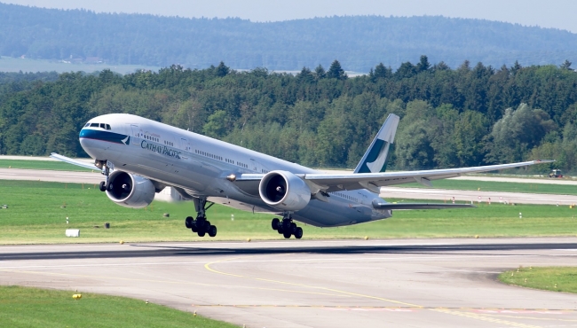 A Cathay Pacific Boeing 777-300 aircraft taking off from a runway