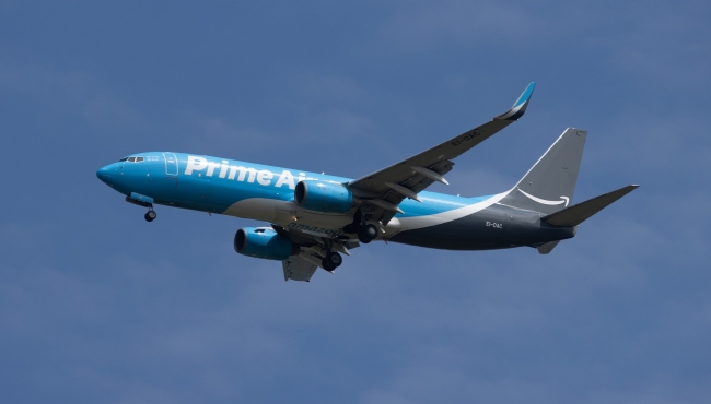 An Amazon Prime Air Boeing 737-800BCF aircraft in flight with high lift devices and landing gear extended
