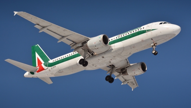 An image of an Alitalia Airbus A320-200 in flight with landing gear wheels and flaps extended