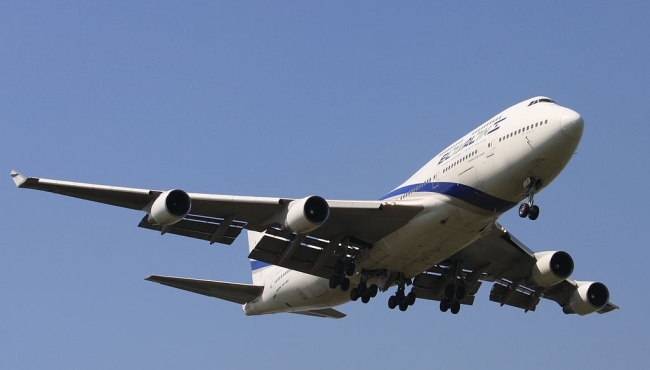 a boeing 747 jet passenger aircraft on takeoff with a blue sky in the background
