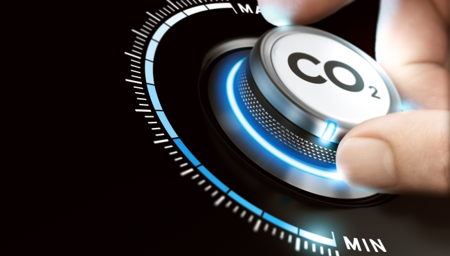 concept image: CO2 dial being turned by a hand