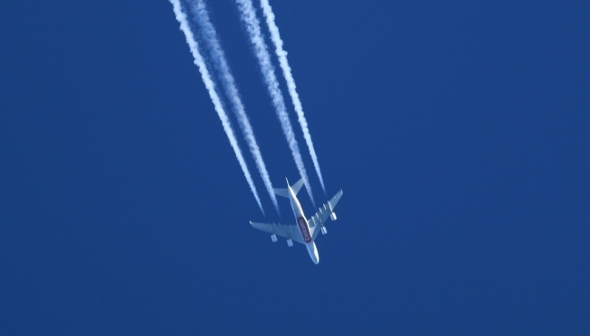 an aircraft in flight in a blue sky