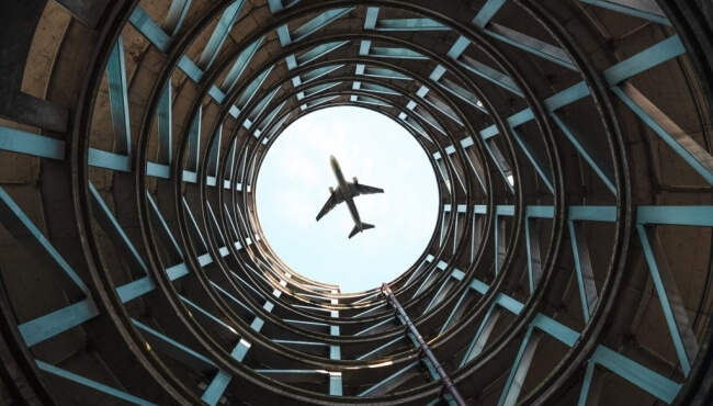 image of an aeroplane flying from below