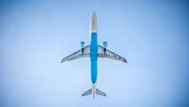 image of a plane in a blue sky