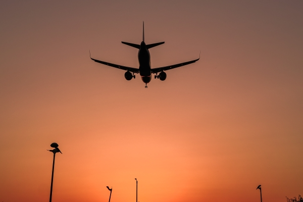 Image of an aeroplane flying in sunset